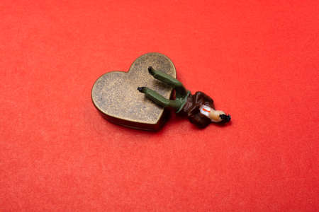 Man figurine on a Heart shape as love conception