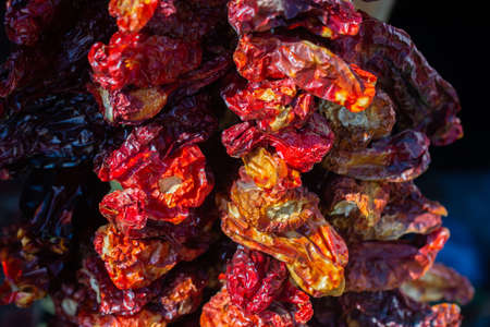 A Lot of dried Red Peppers hanging found as food backgroundの写真素材