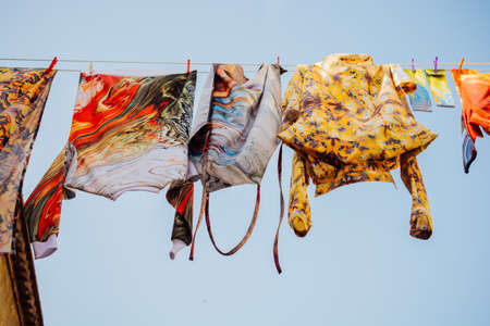 Clothes hanging from a clothes line rope in the streetの写真素材