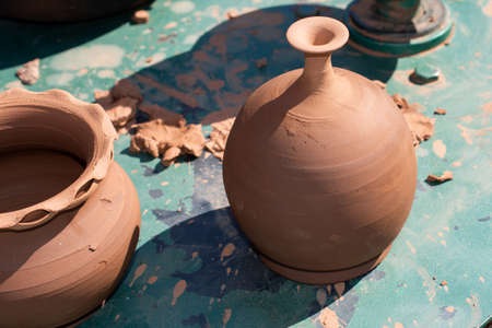 making anshaping up the clay of the pot