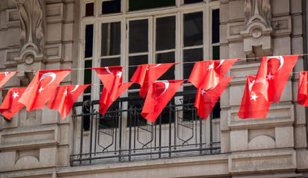 Turkish national flag hang on a pole on a rope in the street in open air