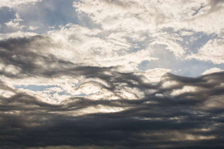 Grey color clouds partly cover the sky in the daytime