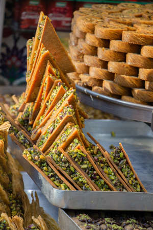 Turkish traditional dessert Kadayif  baked in syrup served with nut powderの写真素材