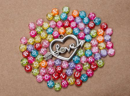 Heart shape and love wording amid colorful alphabet letters