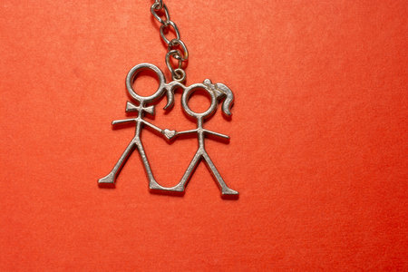 Boy and girl icon made of wire on red color