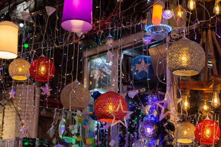 Modern colorful lamps in retro style. Bright, colorful lights hang in an electrical store