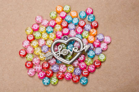 Heart shape and love wording amid colorful alphabet lettersの写真素材