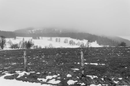 Poland, Foggy winter day in the mountains, field fence.の写真素材