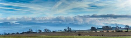 Poland, panorama hanging clouds over a mountain range.の写真素材