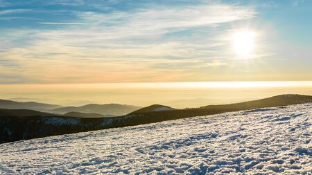 Eastern Sudetes, winter sunset over the panorama of mountain peaks.