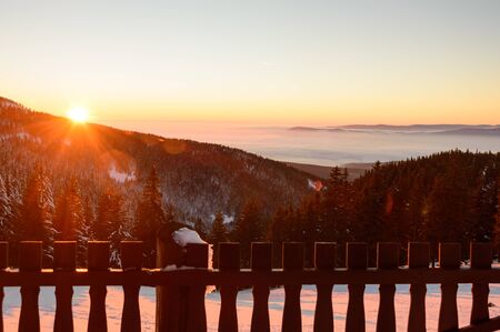 Golden sunset in the mountains, a vast fog over the valleyの写真素材
