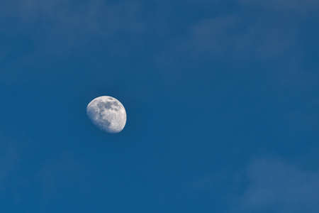 Observation of the moon against the sky, clearly visible artificial earth satellite. A view from the...