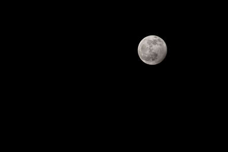 Full moon on a black cloudless sky. A natural satellite. A natural satellite in space, a view from Earth.の写真素材