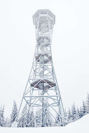 A snow-covered steel lookout tower on top of the Klodzka Mountain. Winter landscape in the Sudetes...