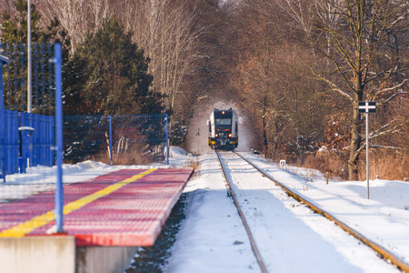 The train is approaching the train station on a winter day.のeditorial素材