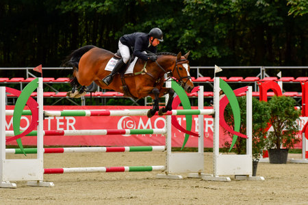 Strzegom October Festival, Morawa, Poland - October, 17, 2021: British competitor James Sommerville on horse Talent jumps through the station during the competition. He took second place on the podiumのeditorial素材