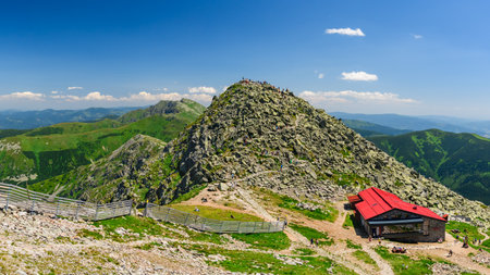 Chopok peak in the Low Tatras in Slovakia with the mountain chalet Kamenna chata. Mountain landscape in the Low Tatras National Park, rocky mountains with trails for hikingの写真素材