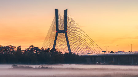 Wroclaw Redzinski bridge over the Odra river in the late evening after sunset. Thick fog over the river on a cool evening, highway.の写真素材