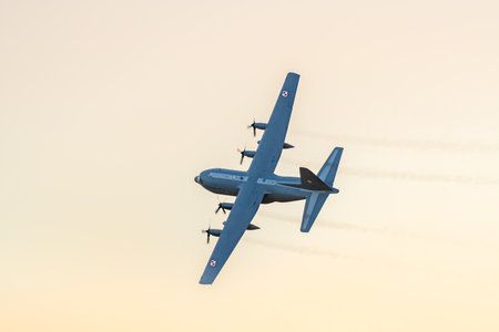 Leszno, Poland - June, 22, 2024: Antidote Airshow Leszno, C-130 Hercules, turboprop powered military transport aircraft. The pilot presents the plane by performing maneuvers in the air at sunset.のeditorial素材