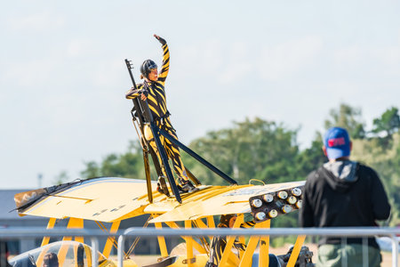 Leszno, Poland - June, 22, 2024: Antidote Airshow Leszno, Scandinavian Airshow Catwalk, Grumman G-164A Ag-Cat. The acrobat greets the audience by waving her hand from the wing of the plane.のeditorial素材