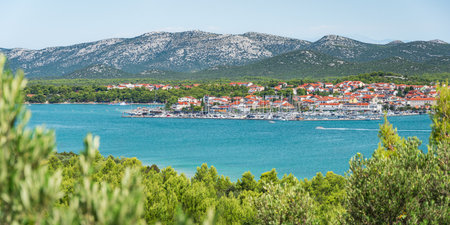 The coastal town of Pirovac in Croatia with its mountainous landscape situated above the sea, viewed...
