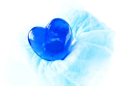 Blue glass heart isolated on white backgroundの写真素材