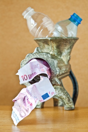 Stylized idea of recycling plastic bottles with grinderの写真素材