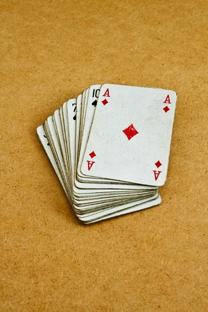 Old deck of playing cards on a wooden tableの写真素材