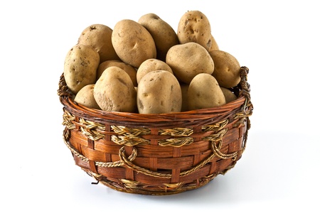 Potatoes in wicker basket isolated on white backgroundの写真素材