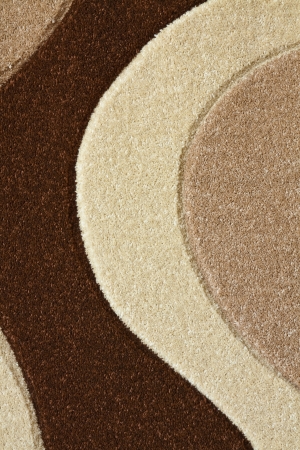 Detail of the carpet in brown, beige and white pastel colors in abstract curvesの写真素材