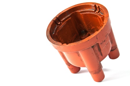 Long exploited and polluted distributor cap on a white background