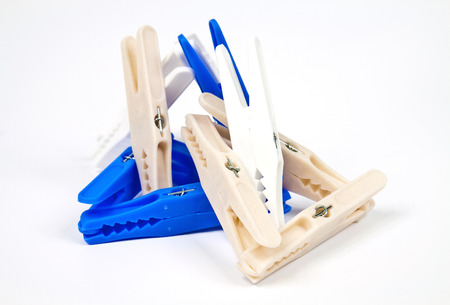 Colored plastic clothes pegs isolated on white backgroundの写真素材