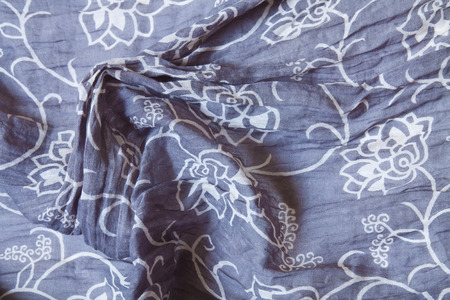 Woven textile fabric with floral motifs in white blue and red