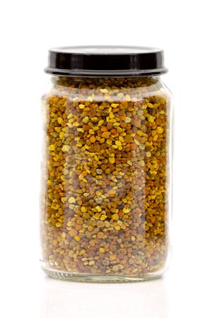 Bee pollen granules in a glass jar. Selective focus with shallow depth of field.の写真素材