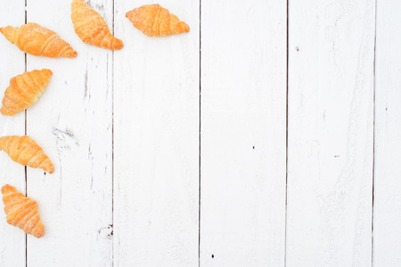 Tiny Croissant Flat Lay on Vintage Backgroundの写真素材