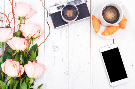 Travelling Concept with Vintage Camera on White Wooden Background and Pink Rose Bouquet, Flat Lay Style, Free Text Spaceの写真素材