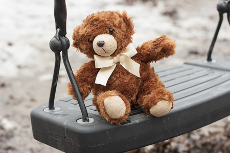 Brown Teddy bear on Swingの写真素材