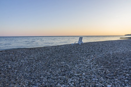 sunbed on the pebbly beach near the sea at sunset, Abkhaziaの写真素材