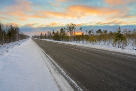 road in winter at dawn in Russiaの写真素材
