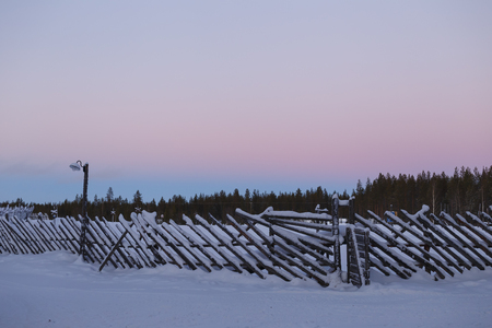 old vintage fence in winter in the villageの写真素材