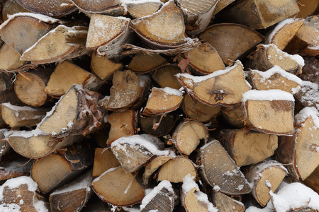 firewood snow covered wood in winterの写真素材