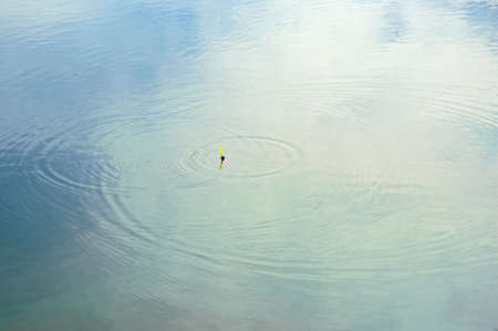 Float rods on the blue water. Waiting for a bite.の写真素材