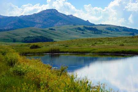 Mountains against the background of the water. Kazakhstan. The Karkaraly Mountains.の写真素材