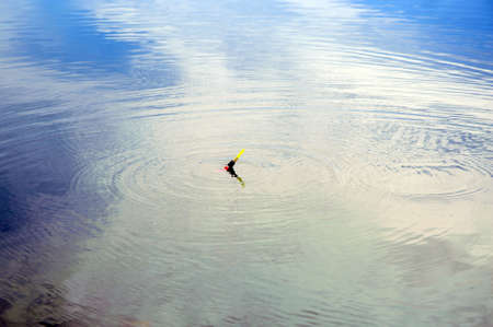 Float rods on the blue water. Waiting for a bite.の写真素材