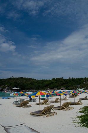 sun bath chairs and colorful parasol at Raya island in Phuketのeditorial素材