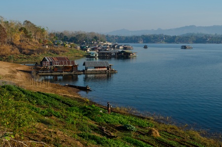 farm and village along a river in Thailandの写真素材