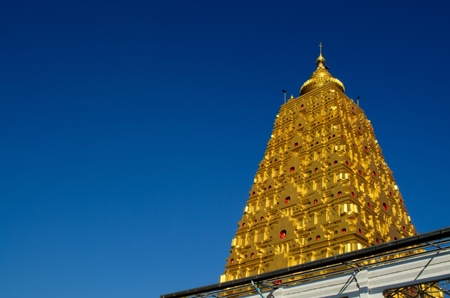 golden pagoda at buddhist temple in Thailandの写真素材