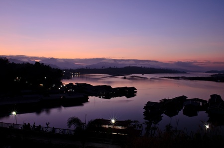 floating house and bridge in Kanchanaburee, Thailand at dawnの写真素材