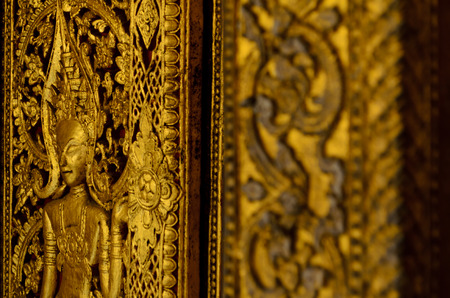 golden sculpture of buddhist temple in Luang Prabangの写真素材