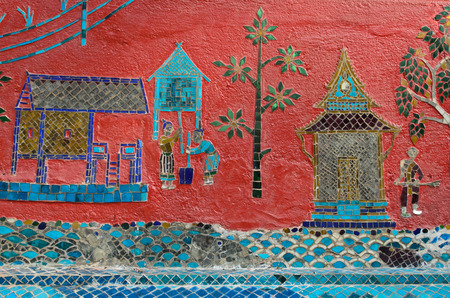 mosaic on pink wall of Wat Xieng Thong buddhist temple in Luang Prabang Laoの写真素材